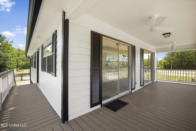 5061 1st Ave, Bay Saint Louis, MS 39520 - wooden porch with ceiling fan