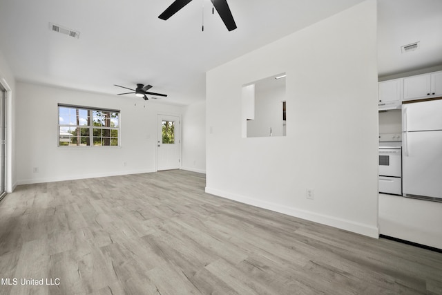 5061 1st Ave, Bay Saint Louis, MS 39520 - unfurnished living room featuring ceiling fan, light wood-type flooring, and baseboards