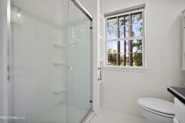 5061 1st Ave, Bay Saint Louis, MS 39520 - bathroom with a shower stall, toilet, vanity, baseboards, and tile patterned flooring