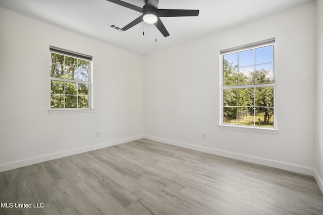 5061 1st Ave, Bay Saint Louis, MS 39520 - empty room with ceiling fan, light wood-style flooring, and baseboards