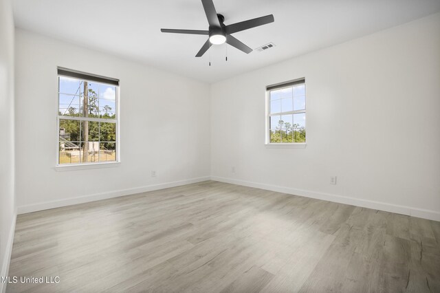 5061 1st Ave, Bay Saint Louis, MS 39520 - spare room with healthy amount of natural light, light wood-style floors, baseboards, and ceiling fan