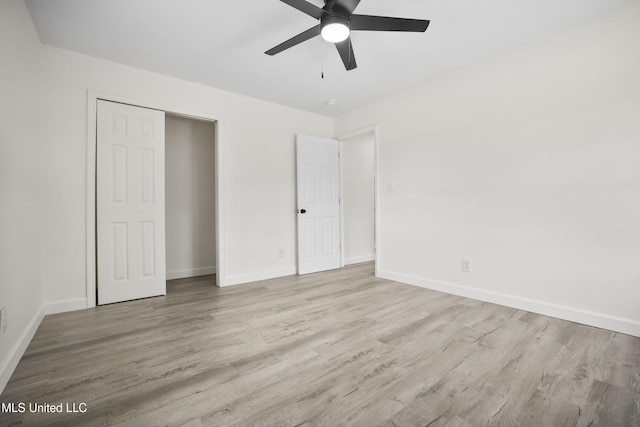5061 1st Ave, Bay Saint Louis, MS 39520 - unfurnished bedroom featuring wood finished floors, baseboards, and ceiling fan