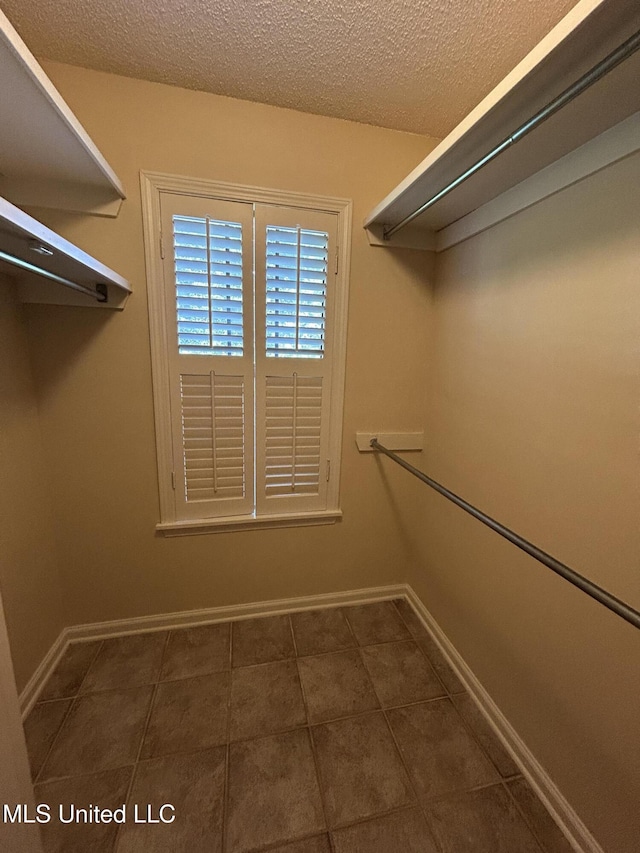 1171 S Bayou Rd, Boyle, MS 38730 - spacious closet featuring dark tile patterned floors
