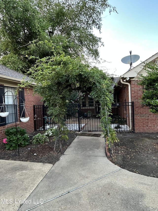 1171 S Bayou Rd, Boyle, MS 38730 - view of front facade featuring brick siding, a gate, and a shingled roof
