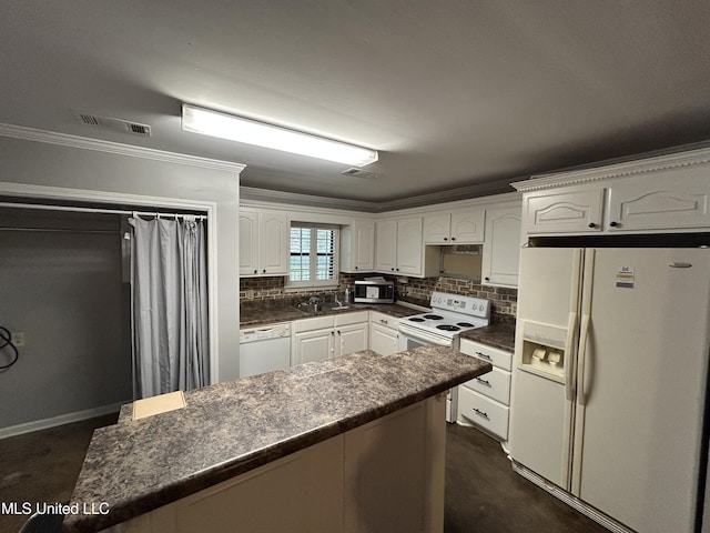 1171 S Bayou Rd, Boyle, MS 38730 - kitchen featuring white appliances, dark countertops, crown molding, white cabinetry, and backsplash