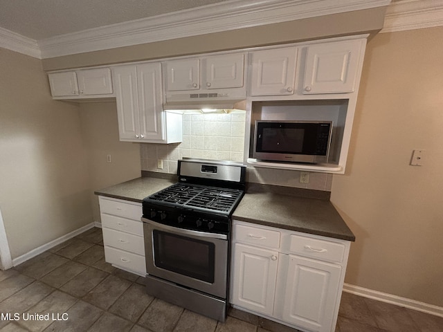 1171 S Bayou Rd, Boyle, MS 38730 - kitchen with appliances with stainless steel finishes, under cabinet range hood, ornamental molding, backsplash, and white cabinetry