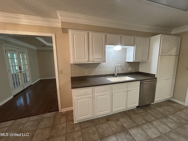 1171 S Bayou Rd, Boyle, MS 38730 - kitchen featuring dishwasher, dark countertops, white cabinets, decorative backsplash, and ornamental molding