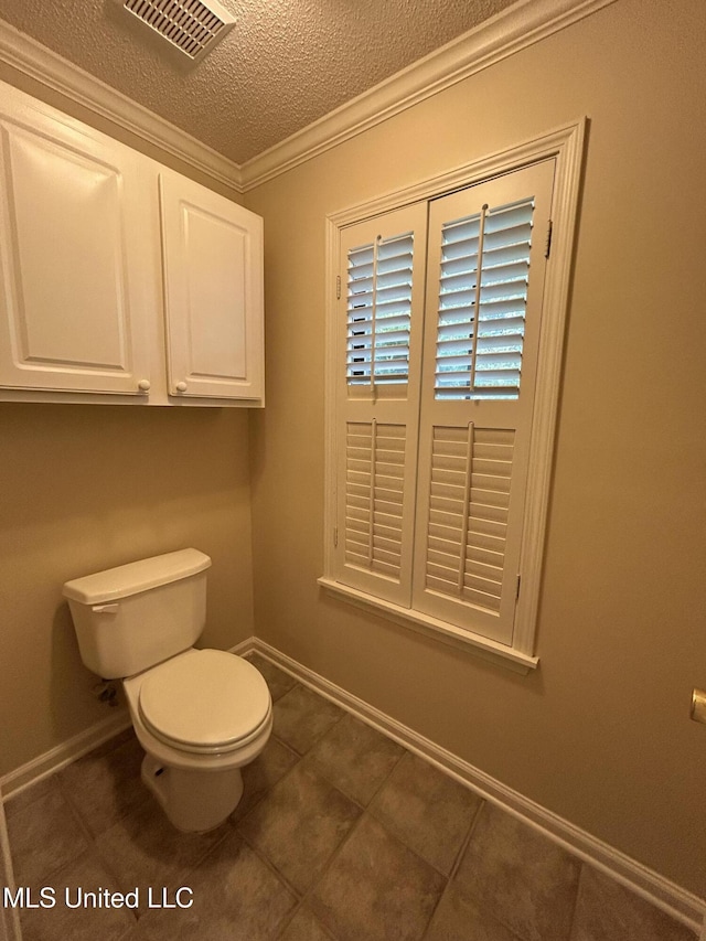 1171 S Bayou Rd, Boyle, MS 38730 - bathroom featuring ornamental molding, a textured ceiling, and tile patterned flooring