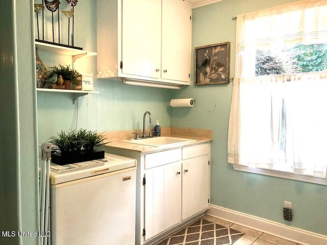 interior space featuring a sink, tile patterned floors, a wealth of natural light, and fridge