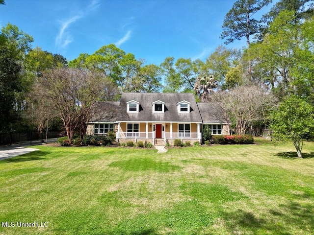 new england style home with a porch and a front lawn