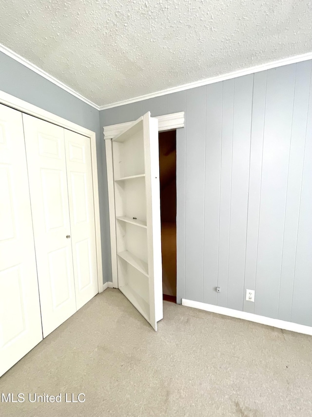 unfurnished bedroom with a closet, carpet flooring, and a textured ceiling