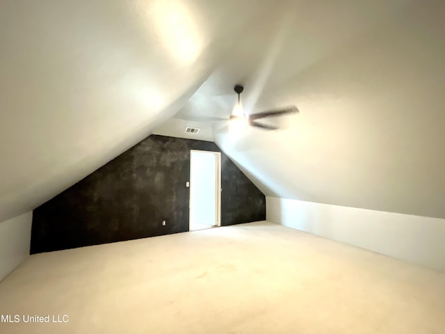 additional living space with carpet floors, vaulted ceiling, and visible vents