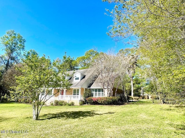 view of front of home featuring covered porch and a front yard