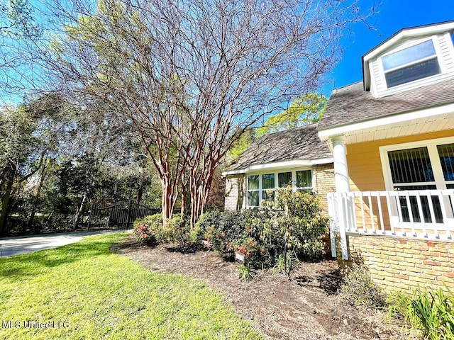 view of property exterior with fence and a yard