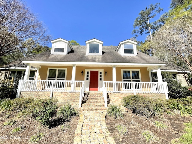 921 Tung Tree Dr, Picayune, MS 39466 - cape cod home featuring a porch and stucco siding