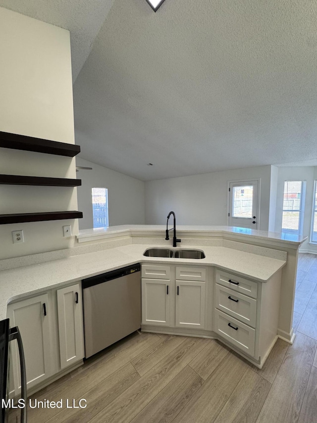 kitchen featuring light wood-style flooring, a sink, open shelves, range, and dishwasher