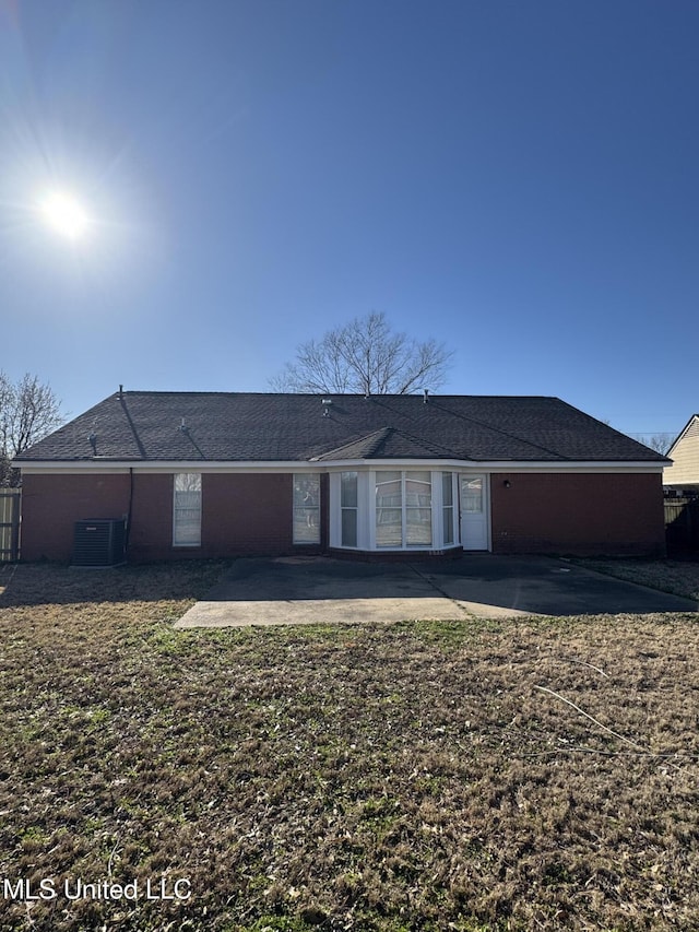 rear view of property with a patio area and cooling unit