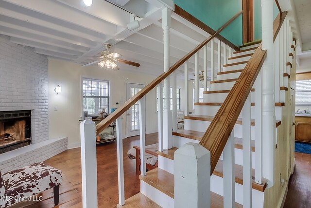 146 Maple Dr, Perkinston, MS 39573 - stairs with wood finished floors, ceiling fan, healthy amount of natural light, a brick fireplace, and beamed ceiling