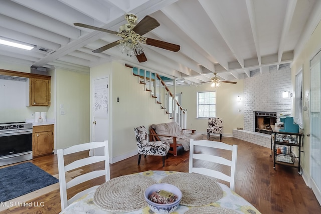146 Maple Dr, Perkinston, MS 39573 - dining space featuring ceiling fan, wood finished floors, beamed ceiling, a fireplace, and baseboards