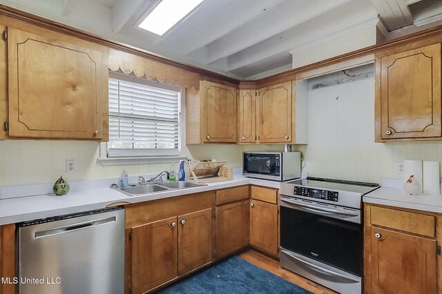 146 Maple Dr, Perkinston, MS 39573 - kitchen with stainless steel appliances, a sink, light countertops, and brown cabinetry