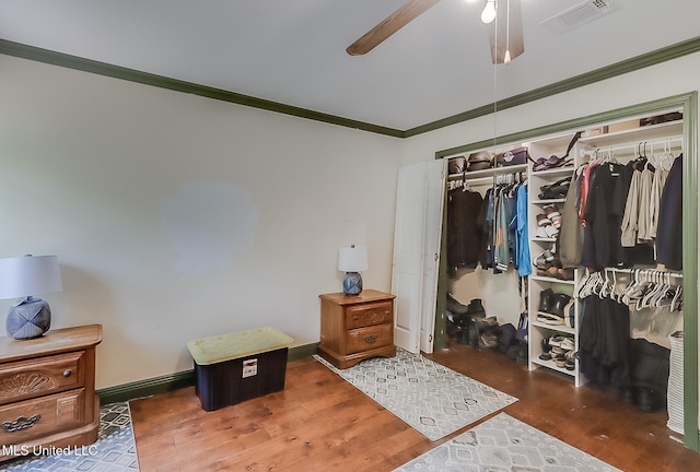 146 Maple Dr, Perkinston, MS 39573 - bedroom with ornamental molding, wood finished floors, a closet, and a ceiling fan