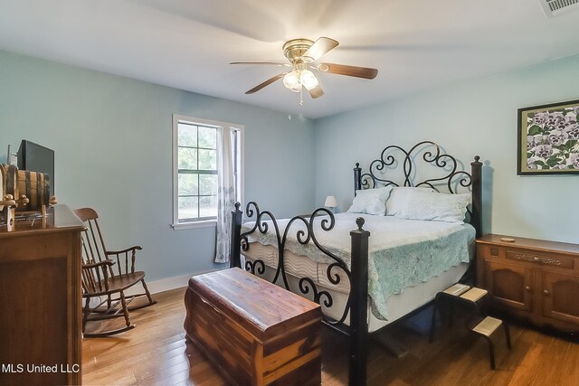 146 Maple Dr, Perkinston, MS 39573 - bedroom with wood finished floors, a ceiling fan, and baseboards