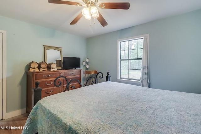 146 Maple Dr, Perkinston, MS 39573 - bedroom featuring wood finished floors, ceiling fan, and baseboards