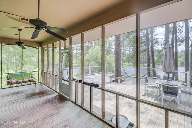 146 Maple Dr, Perkinston, MS 39573 - unfurnished sunroom with a ceiling fan and view of scattered trees