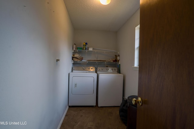 laundry room featuring washing machine and dryer, dark hardwood / wood-style floors, and a textured ceiling