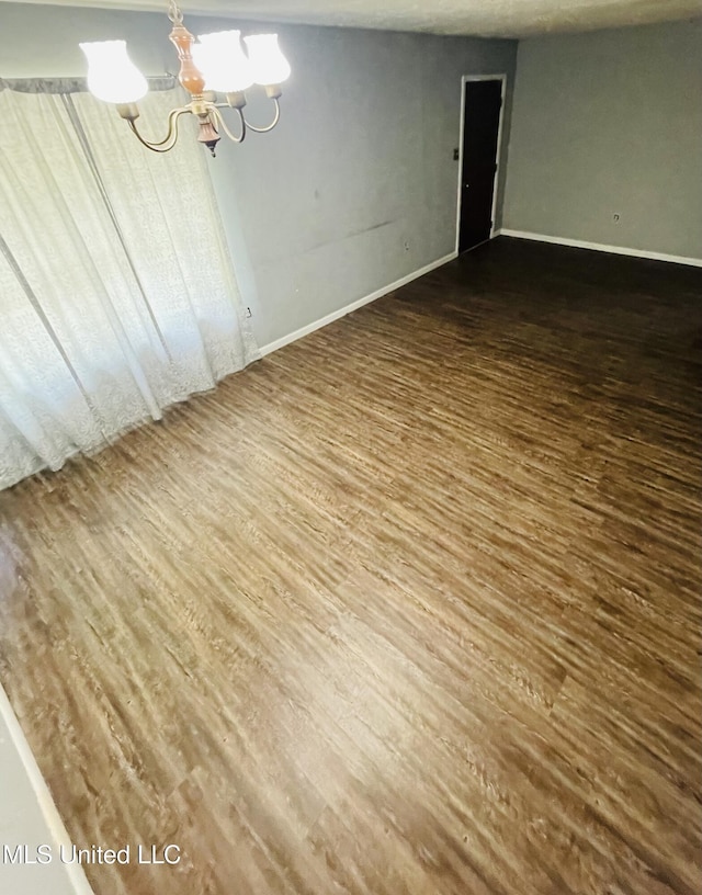111 Brookfield Dr, Natchez, MS 39120 - unfurnished room with a chandelier, wood finished floors, and baseboards