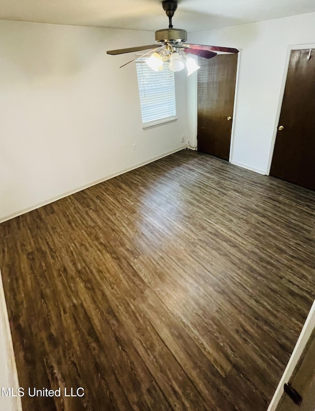 111 Brookfield Dr, Natchez, MS 39120 - unfurnished bedroom featuring dark wood-style flooring, baseboards, and a ceiling fan