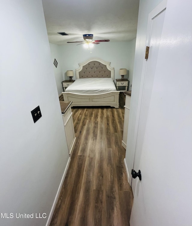 111 Brookfield Dr, Natchez, MS 39120 - bedroom featuring dark wood-style flooring, a ceiling fan, and baseboards