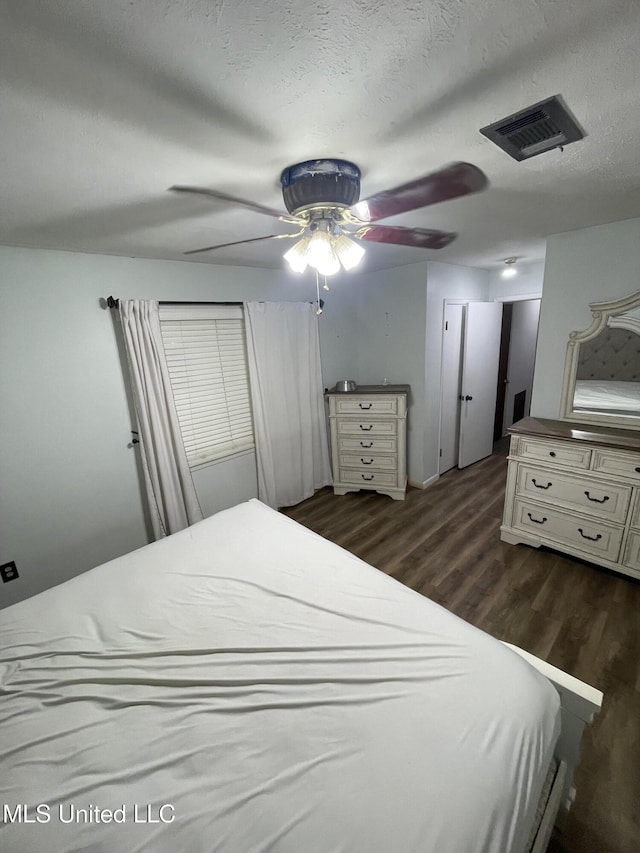 111 Brookfield Dr, Natchez, MS 39120 - bedroom featuring dark wood-style floors, ceiling fan, and a textured ceiling