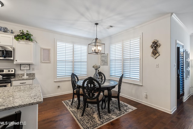 dining room featuring dark wood-type flooring, crown molding, and a chandelier