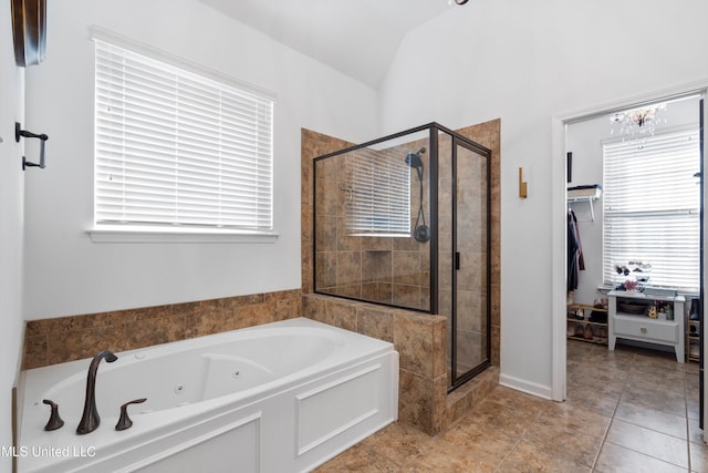 bathroom with plus walk in shower, vaulted ceiling, and a wealth of natural light