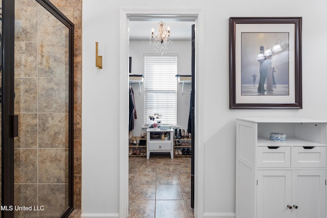 hall featuring an inviting chandelier