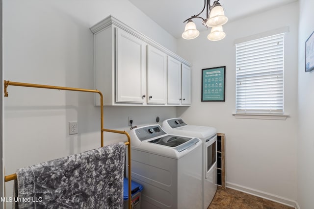 laundry room featuring cabinets, a notable chandelier, a wealth of natural light, and washing machine and clothes dryer