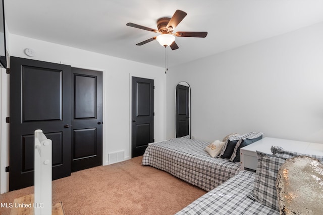 bedroom with light colored carpet and ceiling fan