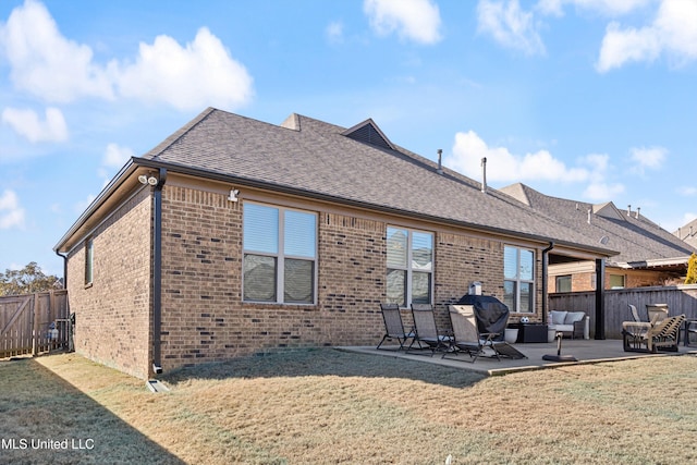 back of house with an outdoor living space, a yard, and a patio area