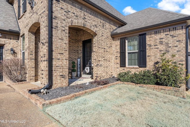 property entrance with a yard