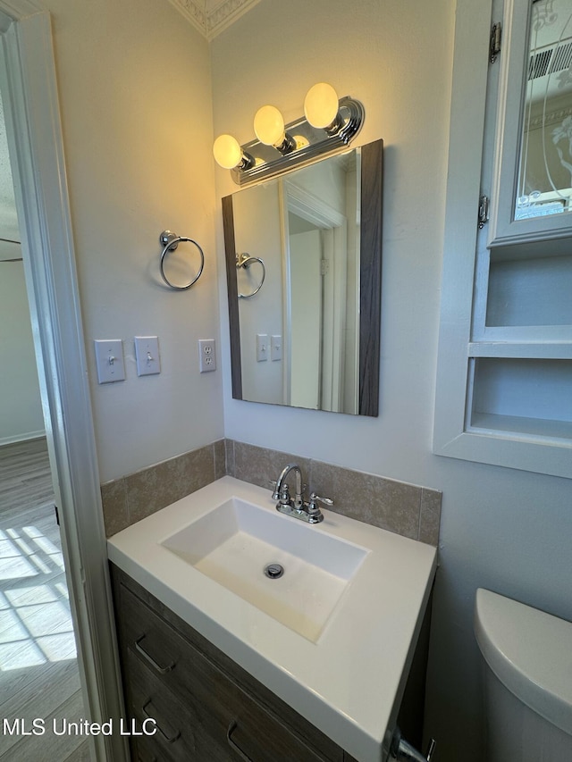 half bathroom featuring toilet and vanity