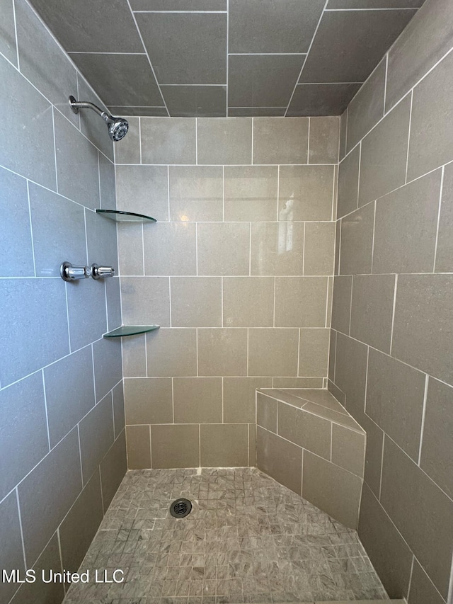 bathroom with tiled shower