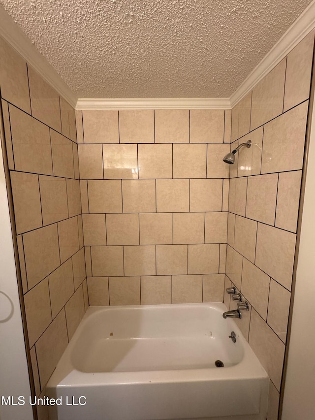 bathroom with a textured ceiling, bathing tub / shower combination, and crown molding