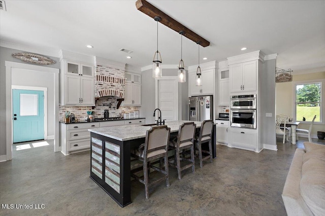 1254 Wade Patrick Rd, Brandon, MS 39042 - kitchen with appliances with stainless steel finishes, tasteful backsplash, concrete floors, a sink, and a breakfast bar