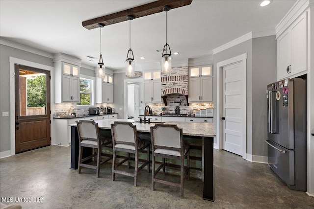 1254 Wade Patrick Rd, Brandon, MS 39042 - kitchen with freestanding refrigerator, backsplash, finished concrete floors, recessed lighting, and ornamental molding