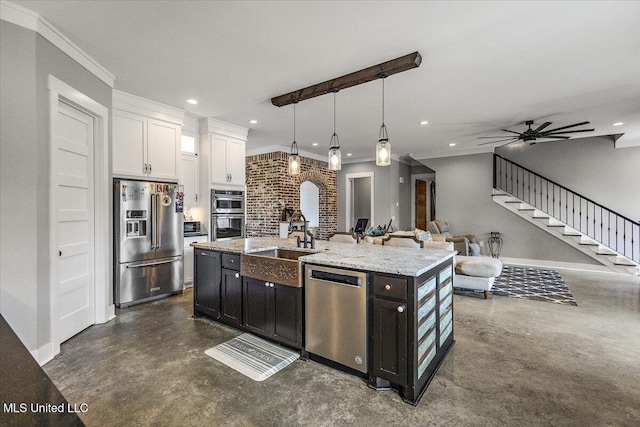 1254 Wade Patrick Rd, Brandon, MS 39042 - kitchen featuring stainless steel appliances, a sink, finished concrete floors, white cabinets, and recessed lighting