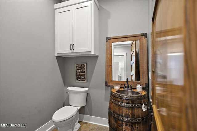 1254 Wade Patrick Rd, Brandon, MS 39042 - bathroom featuring baseboards, toilet, and vanity