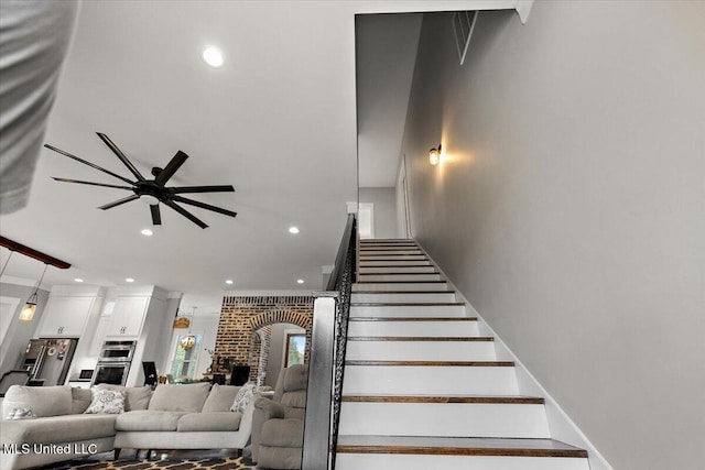 1254 Wade Patrick Rd, Brandon, MS 39042 - stairway with recessed lighting, a ceiling fan, and a brick fireplace