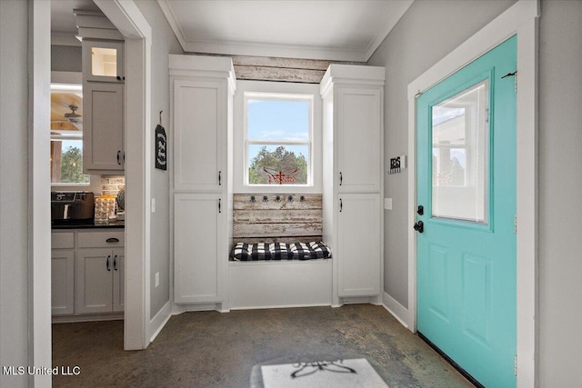 1254 Wade Patrick Rd, Brandon, MS 39042 - entryway featuring ornamental molding, dark colored carpet, and baseboards