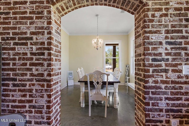 1254 Wade Patrick Rd, Brandon, MS 39042 - dining space with a chandelier, crown molding, brick wall, arched walkways, and finished concrete flooring